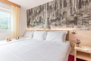 Una cama o camas en una habitación de Hotel Sorapiss