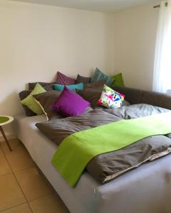 a couch with colorful pillows on top of it at Ferienhaus Zur Mainpforte in Mainz