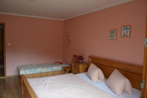 a small bedroom with two beds and a table at Apartmány U Vaců in Železná Ruda