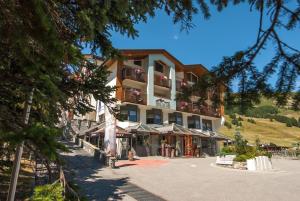 a large building with balconies on the side of a street at Hotel Lac Salin Spa & Mountain Resort in Livigno