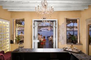 a dining room with a table and a chandelier at Cretan Renaissance in Chania Town