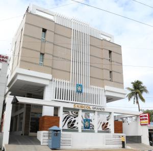 a building with a taroc games sign in front of it at Kiscol Grands Hotel in Coimbatore