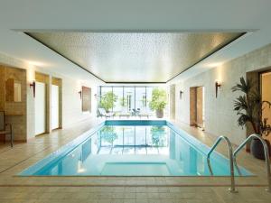 a large swimming pool in a building at Hotel Villa Hügel in Trier