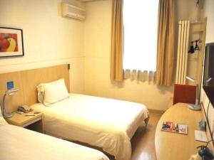 um quarto de hotel com duas camas e uma janela em Jingjiang Inn Xi'an Jianguomen em Xian