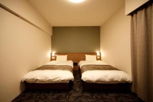 Una cama o camas en una habitación de Dormy Inn Nagano