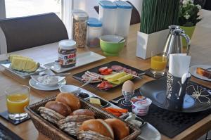 une table recouverte de assiettes de nourriture et de jus d'orange dans l'établissement Frankfurt Bed & Breakfast, à Francfort-sur-le-Main