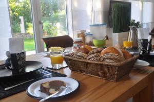 - une table avec un panier de pain et de jus d'orange dans l'établissement Frankfurt Bed & Breakfast, à Francfort-sur-le-Main