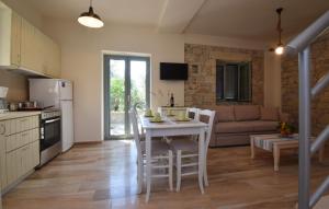 a kitchen and living room with a table and chairs at Kastro-Kardamili in Kardamili