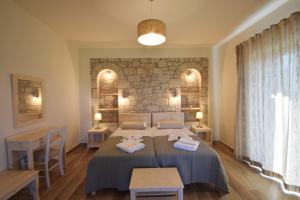 a bedroom with two beds with towels on them at Kastro-Kardamili in Kardamili