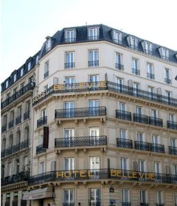 a large white building with a sign on it at Hotel Bellevue Saint-Lazare in Paris