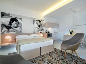 A bed or beds in a room at Duomo Suites & Spa