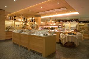 a restaurant with two tables in the middle of a room at Hotel Lac Salin Spa & Mountain Resort in Livigno