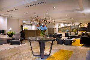 um lobby com uma mesa com um vaso de flores em Inn at the Market em Seattle