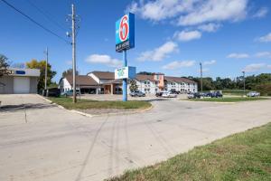 a sign for a gas station on a street at Motel 6-Waterloo, IA in Waterloo