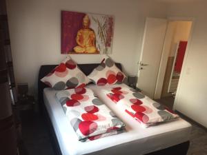 a bed with two pillows and a buddhaphasis at Sunny´s Hotel & Residence in Mainz