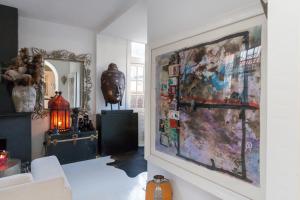 a living room with a large painting on the wall at Apartment Naarden-Vesting in Naarden