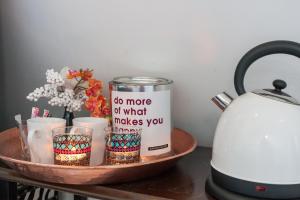 a tray with a can on a table next to a kettle at Apartment Naarden-Vesting in Naarden