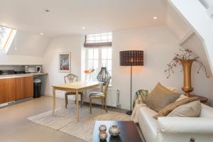 a living room with a couch and a table at Apartment Naarden-Vesting in Naarden