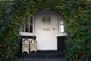 a white door with two chairs in front of it at Apartment Naarden-Vesting in Naarden