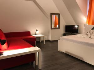 a room with a bed and a couch and a tv at INSIDE Five in Zürich