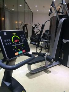 a gym with a cell phone on a treadmill at Palace Hotel & SPA La CONCHIGLIA D' ORO in Vicenza