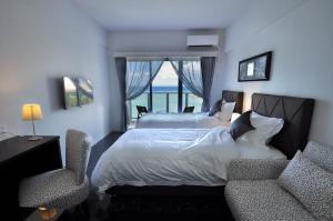 A bed or beds in a room at Beach Front Tower Mihama by DSH