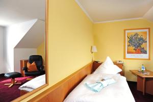 מיטה או מיטות בחדר ב-Landhotel Plauen - Gasthof Zwoschwitz