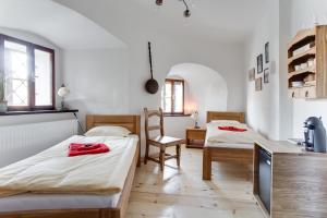 A bed or beds in a room at Krumlov Tower