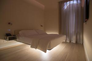 a bedroom with a large bed with a window at Verona Design in Verona