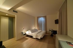 a bedroom with a white bed and a window at Verona Design in Verona