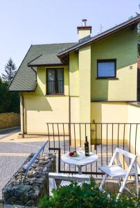 a table and two chairs in front of a house at Sweet Family Home in Cieszyn