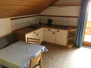 a small kitchen with a table and a sink at Fallerhof in Villnoss