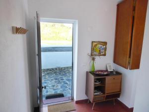 a hallway with a door open to a room at PEDRA DOS CORVOS Beach House in Odeceixe