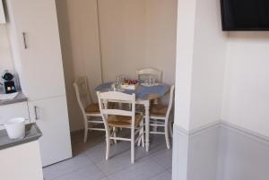 a dining room table with chairs and a blue table at Hotel Saint Georges in Mons