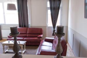 a living room with two couches and a couch at Hotel Saint Georges in Mons