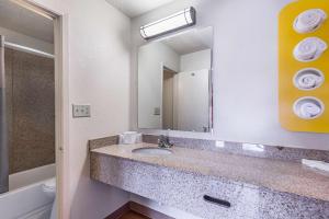 a bathroom with a sink and a mirror at Motel 6-Mount Vernon, IL in Mount Vernon