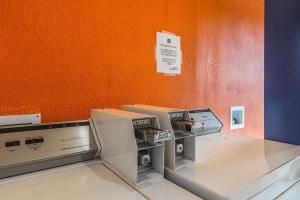 three microwaves sitting on a counter in a room at Motel 6-Mount Vernon, IL in Mount Vernon