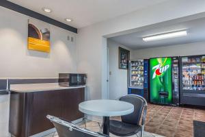 a restaurant with a table and a soda machine at Motel 6-Mount Vernon, IL in Mount Vernon