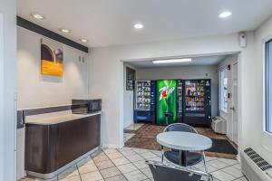 a restaurant with a counter and a table and chairs at Motel 6-Mount Vernon, IL in Mount Vernon