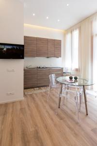 a kitchen with a table and chairs and a television at Le Dimore del Conte in Vicenza