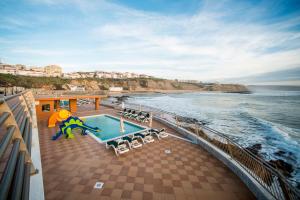 - un balcon d'un bateau de croisière avec une piscine et l'océan dans l'établissement Vila Gale Ericeira, à Ericeira