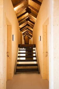 a staircase in a building with wooden ceilings at Alter Schlachthof in Bressanone