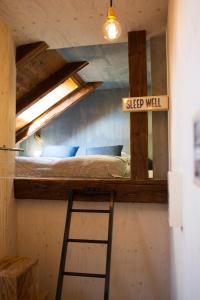 a loft bed with a sign that reads sleep well at Alter Schlachthof in Bressanone