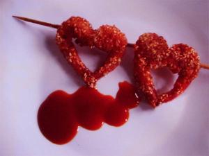 two heart shaped donuts on a stick with red sauce at Golden Lion in Bouillon