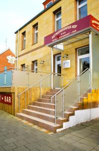 a building with stairs in front of a building at Hotel Dietrichsdorfer Hof in Kiel