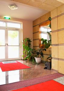 a room with a door and a red rug at Hotel Dietrichsdorfer Hof in Kiel