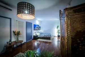 a living room with a bed and a chandelier at Mi&Ti Bed&Breakfast in Vicenza