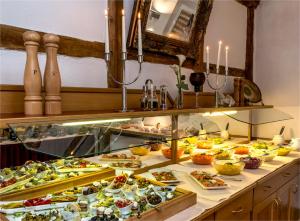 a buffet line with many different types of food at Hotel Gut Voigtlaender in Blankenburg