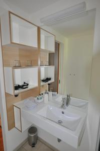 a bathroom with a white sink and a mirror at Volkspark in Bamberg