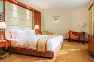 a hotel room with a bed and a desk at Grandview Hotel Macau in Macau